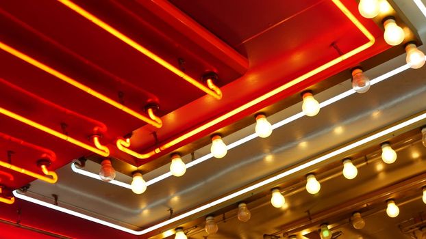 Old fasioned electric lamps blinking and glowing at night. Abstract close up of retro casino decoration shimmering in Las Vegas, USA. Illuminated vintage style bulbs glittering on Freemont street.