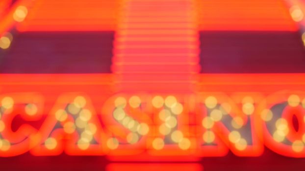 Defocused old fasioned electric lamps glowing at night. Abstract close up of blurred retro casino decoration shimmering, Las Vegas USA. Illuminated vintage style bulbs glittering on Freemont street.