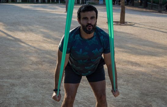 Man playing sports in a park in the afternoon and wearing a flower T-shirt