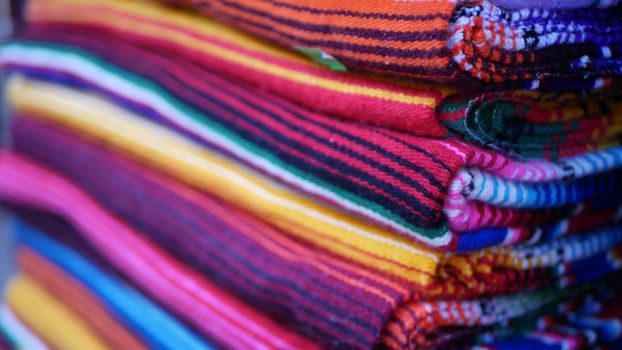 Colorful mexican wool serape blankets texture. Woven ornamental vivid textile with authentic latin american pattern. Striped multi colored fabric for poncho and sombrero. Hispanic indigenous style.