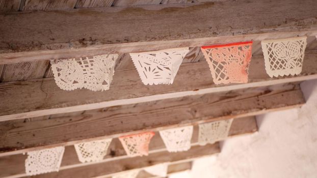 Colorful mexican perforated papel picado banner, festival colourful paper garland. Multi colored hispanic folk carved tissue flags, holiday or carnival. Authentic fiesta decoration in Latin America.