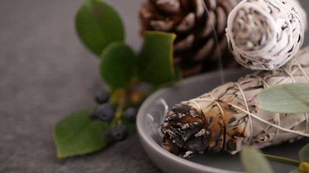 Dried white sage smudge stick, relaxation and aromatherapy. Smudging during psychic occult ceremony, herbal healing, yoga or aura cleaning. Essential incense for esoteric rituals and fortune telling.