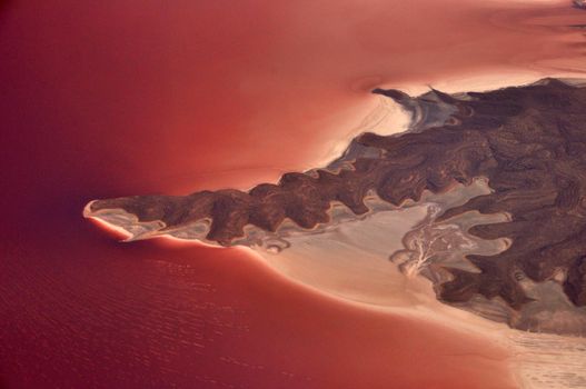 Picturesque view of pink lake, Aerial view of coastline of exotic pink salt Urmia lake with cliff formation, Iran