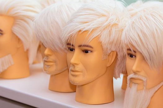 Male mannequins for training hairstyles. Male images with a beard and mustache, close-up.
