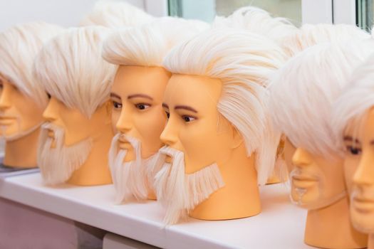 Male mannequins for training hairstyles. Male images with a beard and mustache, close-up.