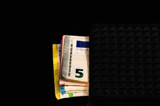 Euro banknotes in black wallet isolated.