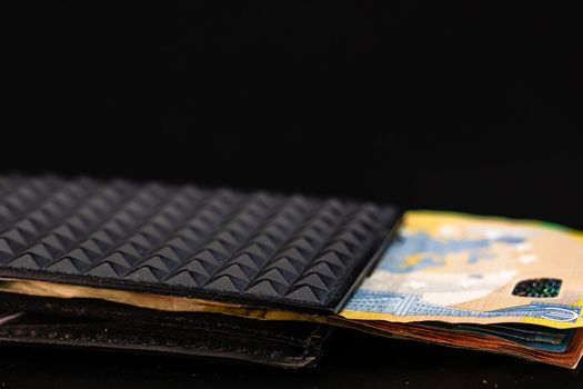 Euro banknotes in black wallet isolated.