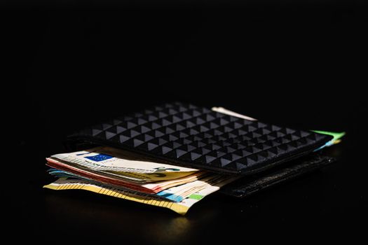 Euro banknotes in black wallet isolated.