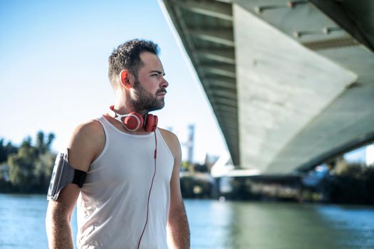 man playing sports and listening to music with headphones