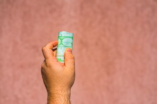 Hand holding showing euro money or giving money like bribe or tips.100 EURO banknotes EUR currency isolated. Concept of rich business people, saving or spending money.