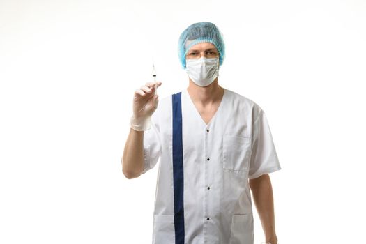 Surgeon holding a syringe in his hands and looking into the frame, isolated on white background