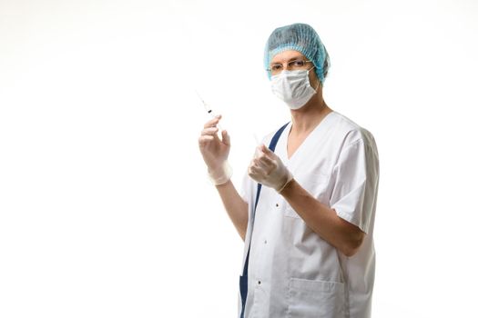 Surgeon holds a syringe in his hands and looked into the frame, isolated on white background