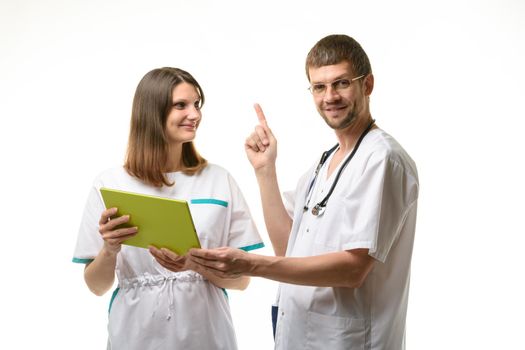 Two doctors discuss the test results, one of them happily threw up a finger
