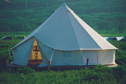 White tent on the background of the natural landscape. Travel and tourism.
