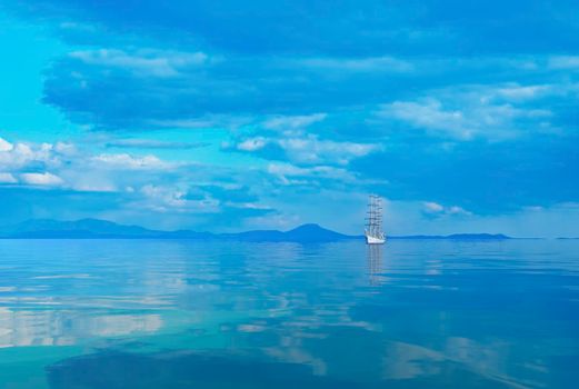 Seascape with a beautiful sailboat on the horizon. Vladivostok, Russia.