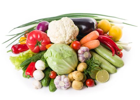 Composition with raw vegetables isolated on white.