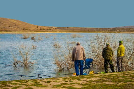 Lake. View from behind Discussing fishing