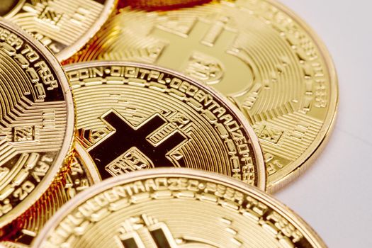 Many gold color coins with bitcoin sign close up