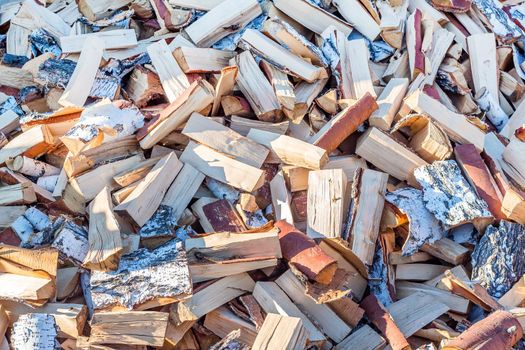 A pile of chopped birch wood. Firewood and biofuels