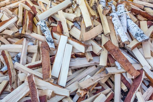 A pile of chopped birch wood. Firewood and biofuels