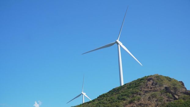Windmills for electric power production. Bangui Windmills in Ilocos Norte, Philippines. Solar farm, Solar power station.