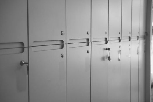 white school lockers and key in locker room