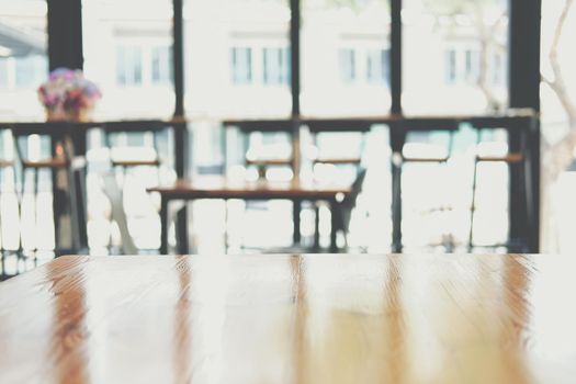 wooden table with cafe coffee shop defocused blur background