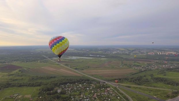 Hot air balloon in the sky over a field in the countryside. Aerostat fly in the countryside.