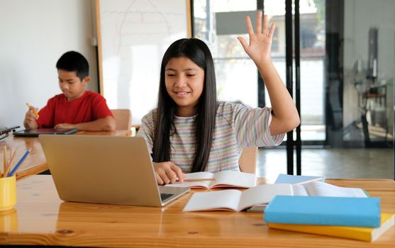 asian girl student raising hand studying learning lesson online. remote meeting distance education at home