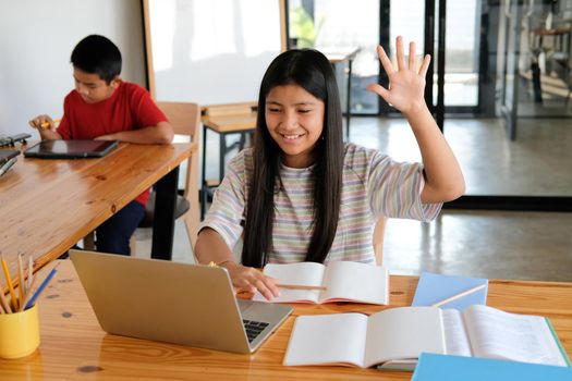 asian girl student raising hand studying learning lesson online. remote meeting distance education at home