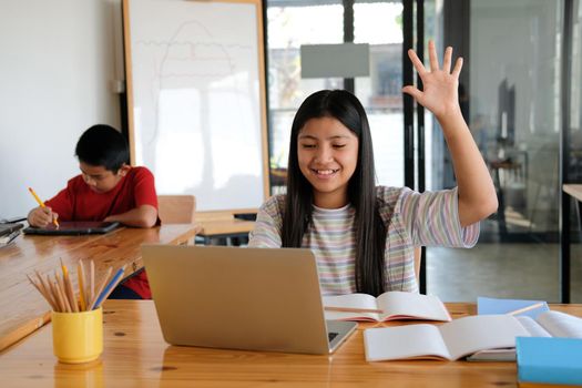 asian girl student raising hand studying learning lesson online. remote meeting distance education at home