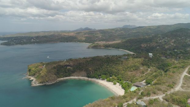 Aerial view of seashore with beach, lagoons and coral reefs. Philippines, Luzon. Ocean coastline with turquoise water. Tropical landscape in Asia.