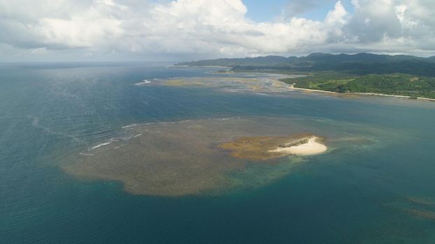 Tropical island with white sandy beach. Aerial view of sandy Crocodile island with colorful reef. Santa Ana Seascape, ocean and beautiful beach. Philippines. Travel concept.