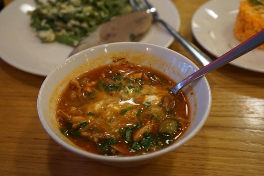 national cuisine hodgepodge soup with pickled cucumbers on a wooden table