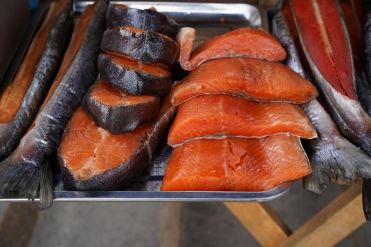 Smoked red fish on a metal tray. Fish market