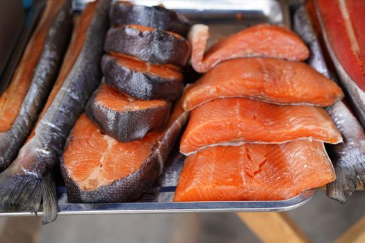 Smoked red fish on a metal tray. Fish market