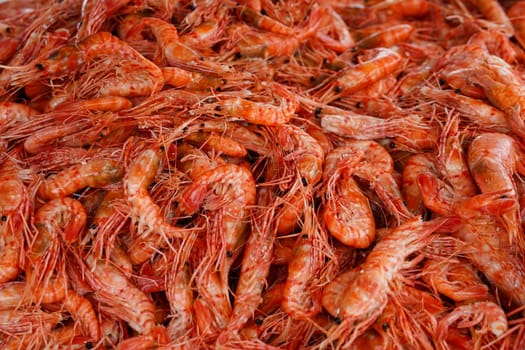 Natural background with lots of red cooked prawns. Seafood and delicacies.