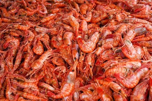 Natural background with lots of red cooked prawns. Seafood and delicacies.