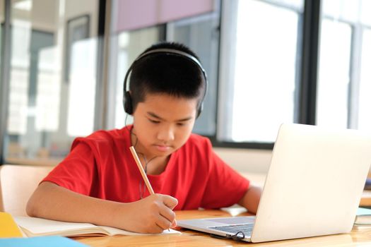 asian boy student studying learning lesson online. remote meeting distance education at home