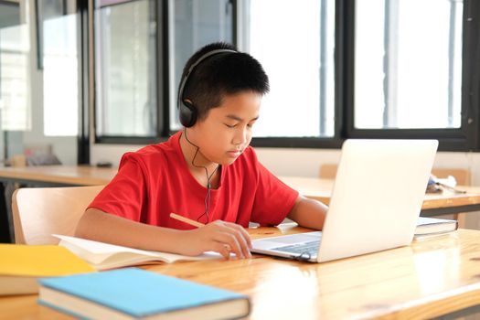 asian boy student studying learning lesson online. remote meeting distance education at home