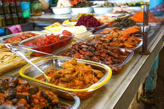 Products of the Yalta market, pickles of vegetables on the counter for sale.