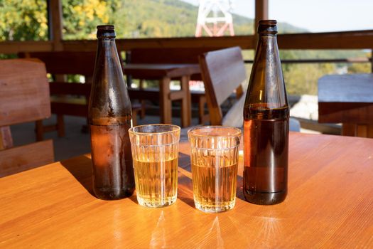 bottles and glasses with lemonade on a wooden table. Slyudyanka, Irkutsk region