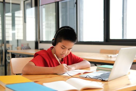 asian boy student studying learning lesson online. remote meeting distance education at home