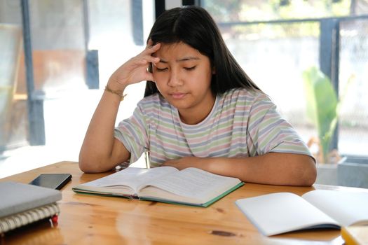 asian girl student studying hard feeling stressed tired exhausted bored. children education