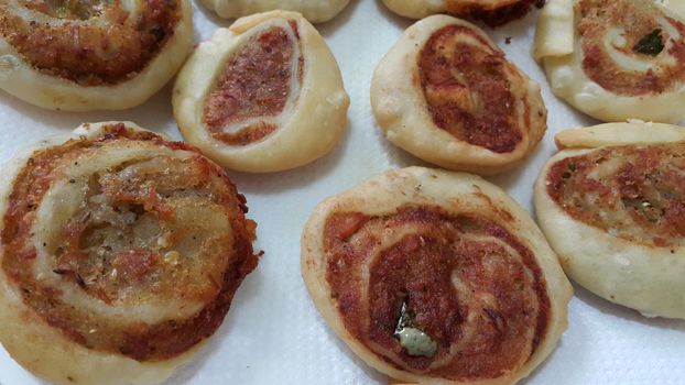 Closeup of delicious home made pinwheel puff pastries food item placed over white background