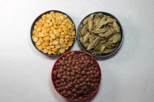 Top view of assortment of cereals, and cardamom. Collection of different spices and cereals.