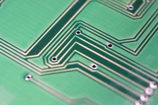 Electronic board with circuit lines and chip. Macro view of green board