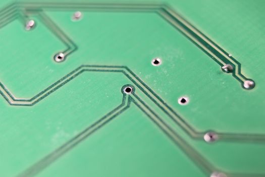 Electronic board with circuit lines and chip. Macro view of green board