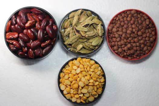 Top view of assortment of cereals, and cardamom. Collection of different spices and cereals.