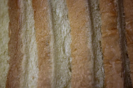 Closeup top view of freshly prepared slices of toast bread. Food background for bakery products